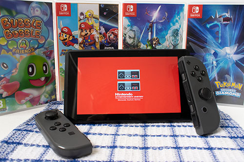 Original photo with games in the background and nintendo switch screen in the front