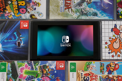 Edited photo of nintendo switch screen surrended by games