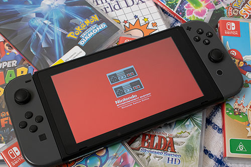 Original photo of nintendo switch with controlers over games