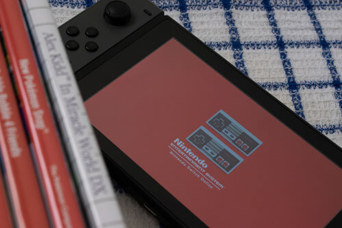 Original photo of games on the side and nintendo switch with controlers on the floor