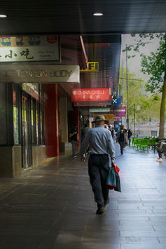 Edited photo with a man walking on the street with a good light  and speed effect